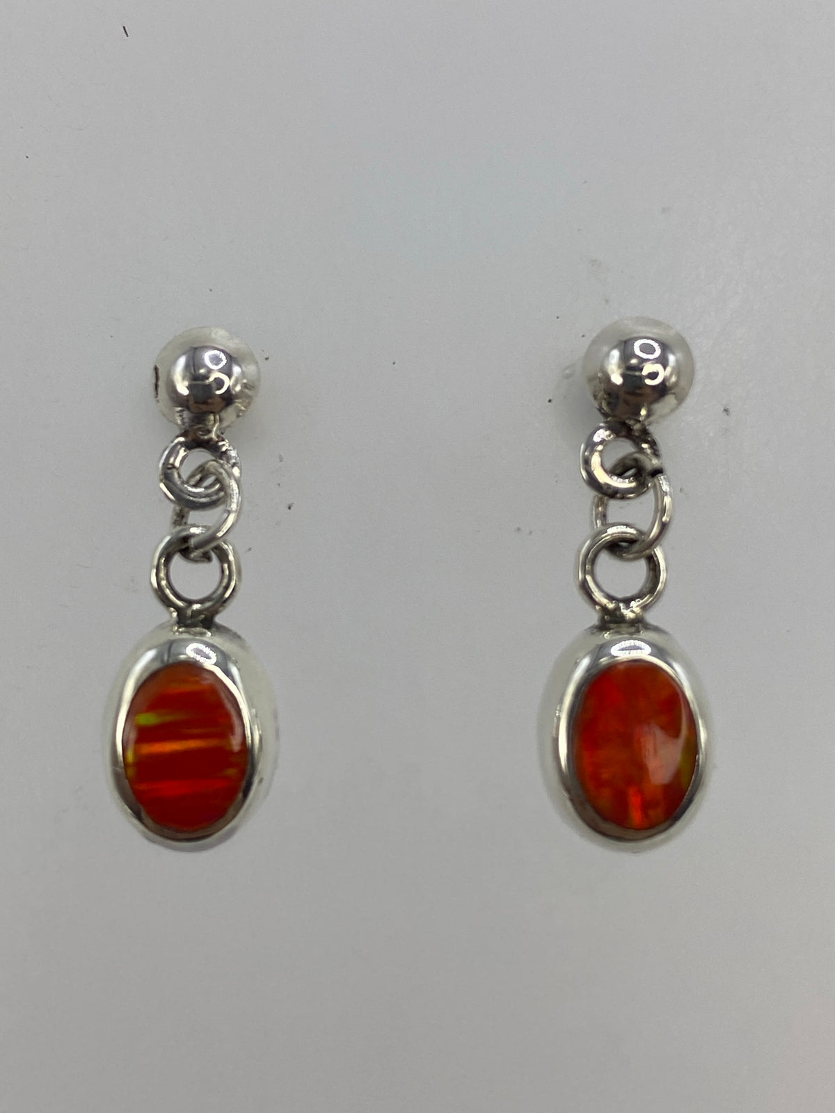 Fire opal earrings on measurement scale showing 2.1 cm length