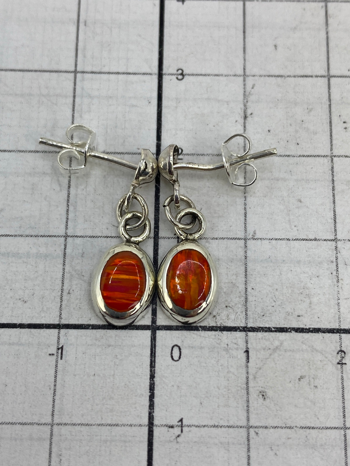 Side profile of the handcrafted fire opal earrings with silver posts