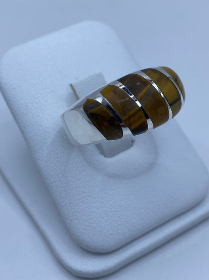 Vista lateral del anillo de plata con piedra de Ojo de Tigre mostrando el engaste a mano