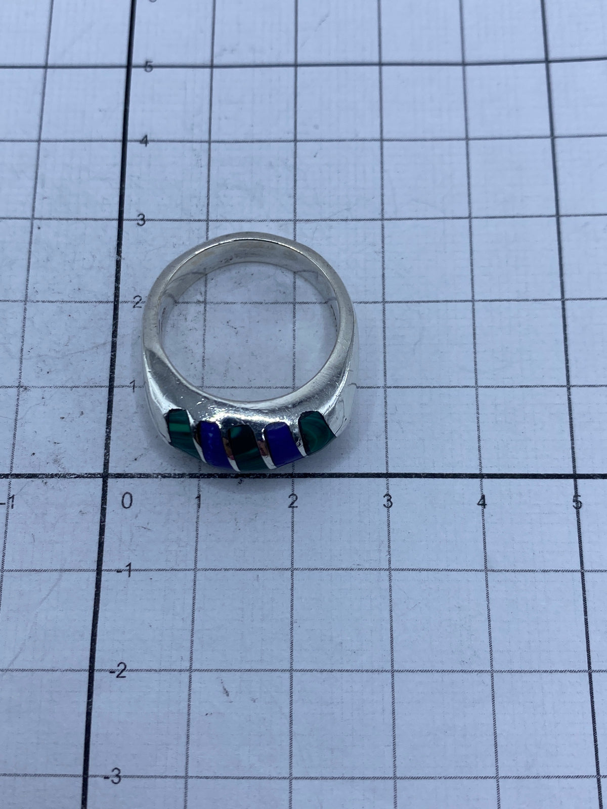 Anillo sobre escala de peso mostrando 12.1 gramos y el SKU del Lote #1