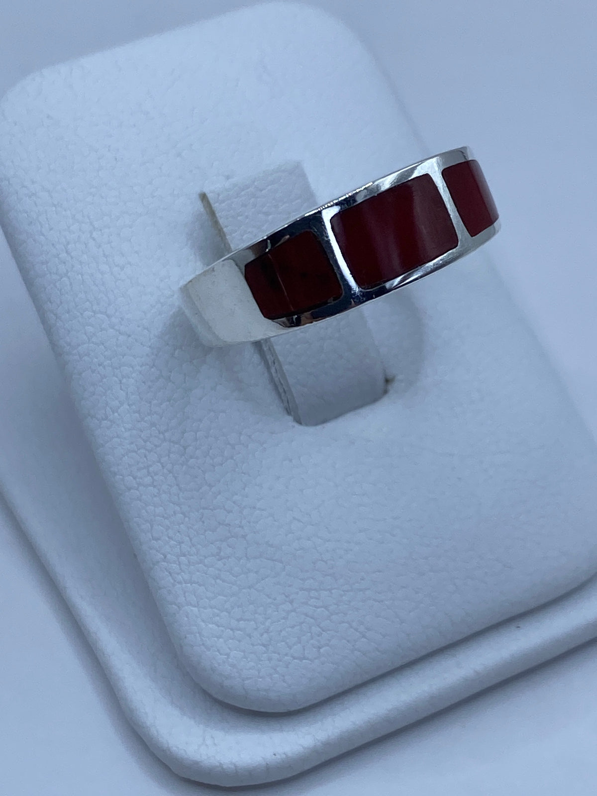 Vista lateral del anillo de plata con coral rojo mostrando el Quinto 925