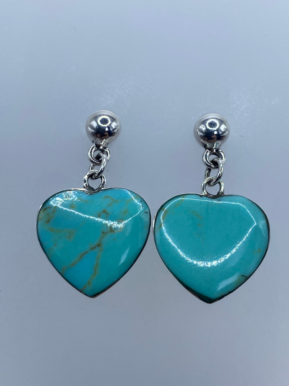 Aretes de turquesa y plata 925 sobre regla métrica mostrando medidas exactas de 2.7 cm