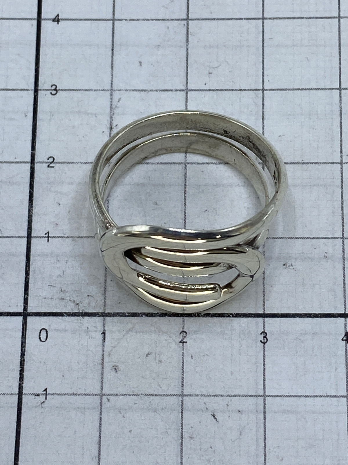 Anillo de plata minimalista usado en la mano, mostrando cómo se ve puesto