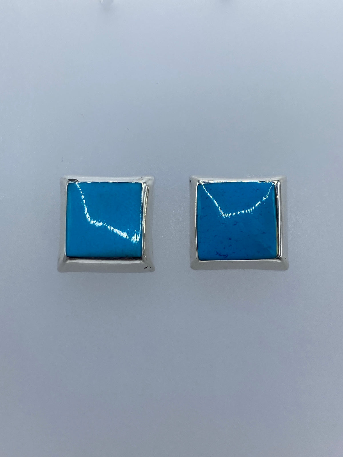 Detalle de un arete mostrando la incrustación de turquesa en plata 925