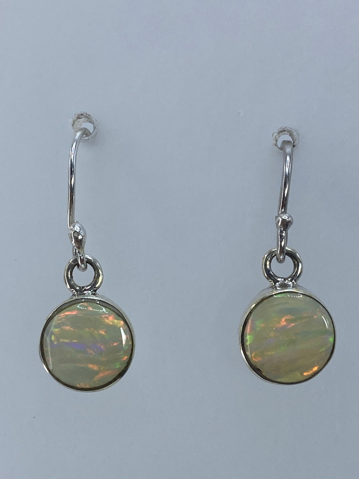 Aretes de plata 950 con ópalo de fuego multicolor en tonos naranja, verde e iridiscente