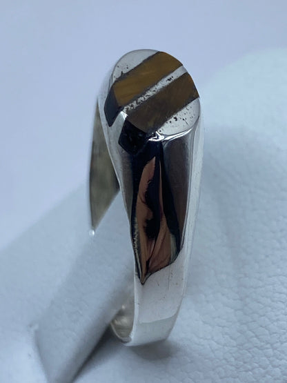 Anillo puesto en mano masculina, ojo de tigre visible desde arriba