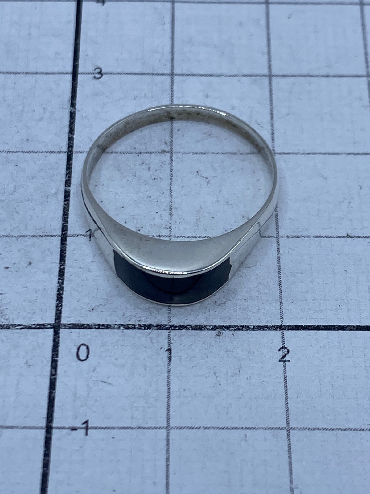Anillo de plata 925 sobre fondo gris mostrando el Quinto hallmark