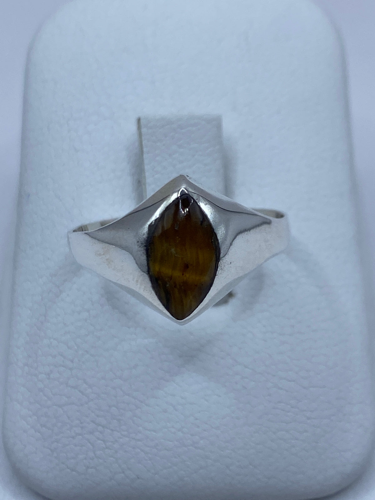Anillo de plata 925 con Ojo de Tigre café engastada, visto de frente sobre fondo blanco