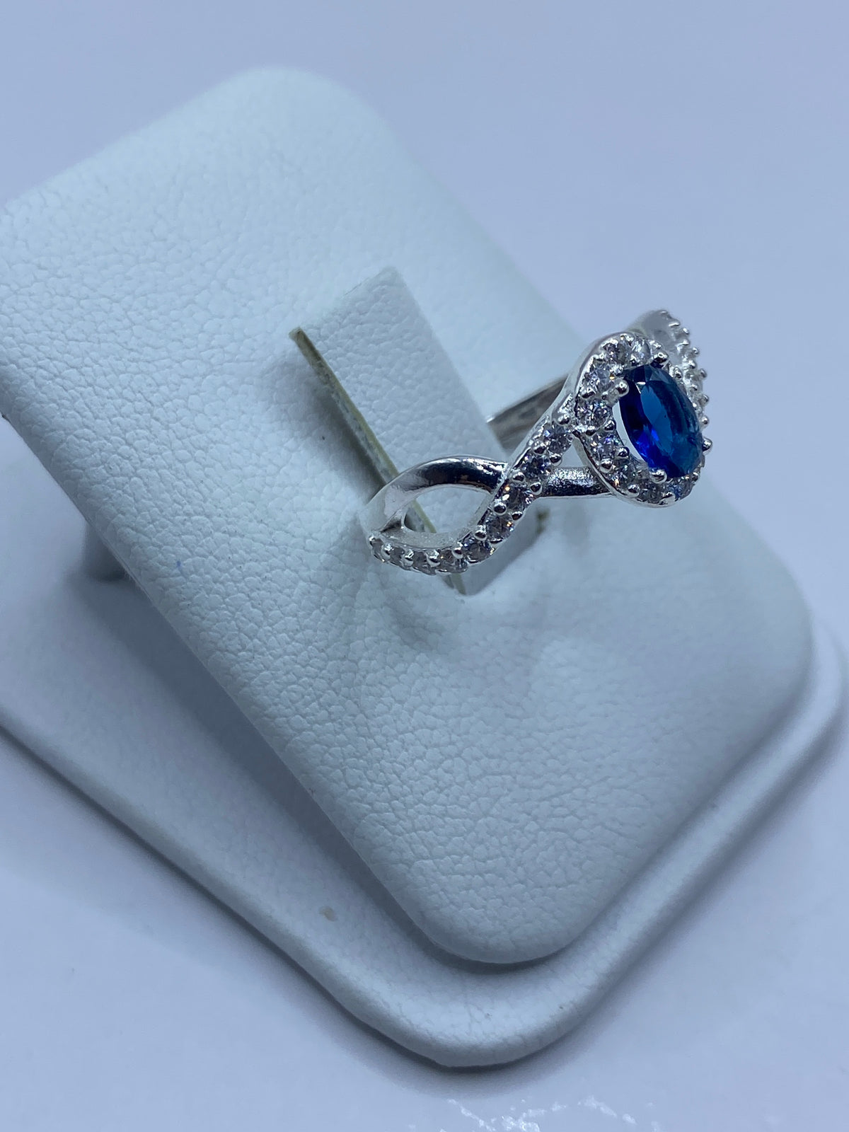 Vista lateral del anillo mostrando el engaste de circonia azul rodeado de micro-circonia blanca