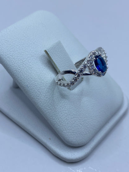 Vista lateral del anillo mostrando el engaste de circonia azul rodeado de micro-circonia blanca