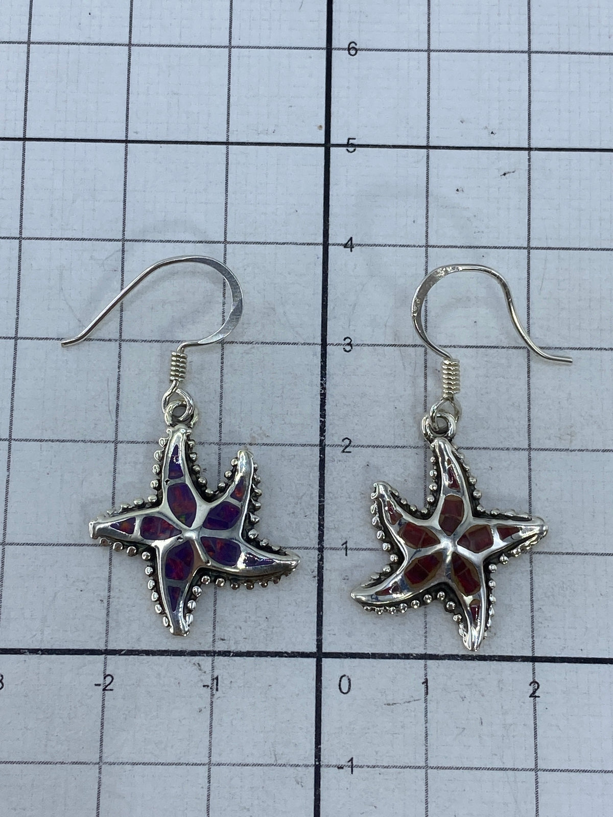 Fire opal earrings displayed on scale showing 5.77g total weight with .950 hallmark