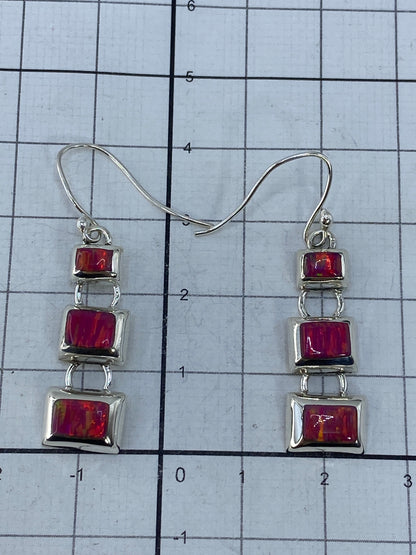 Par de aretes sobre fondo blanco con la marca 925 visible