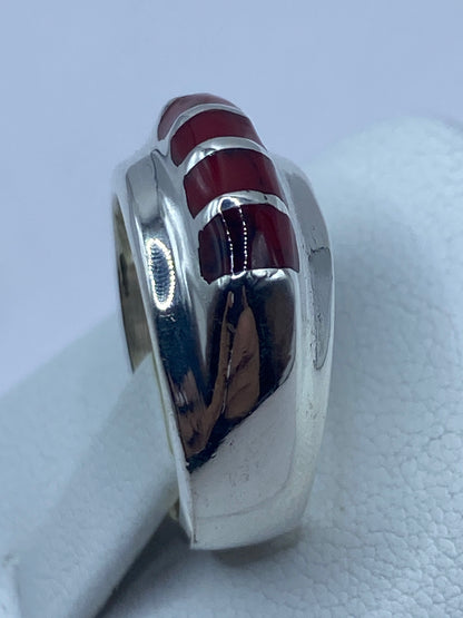 Detalle del engaste a mano del coral rojo con la plata
