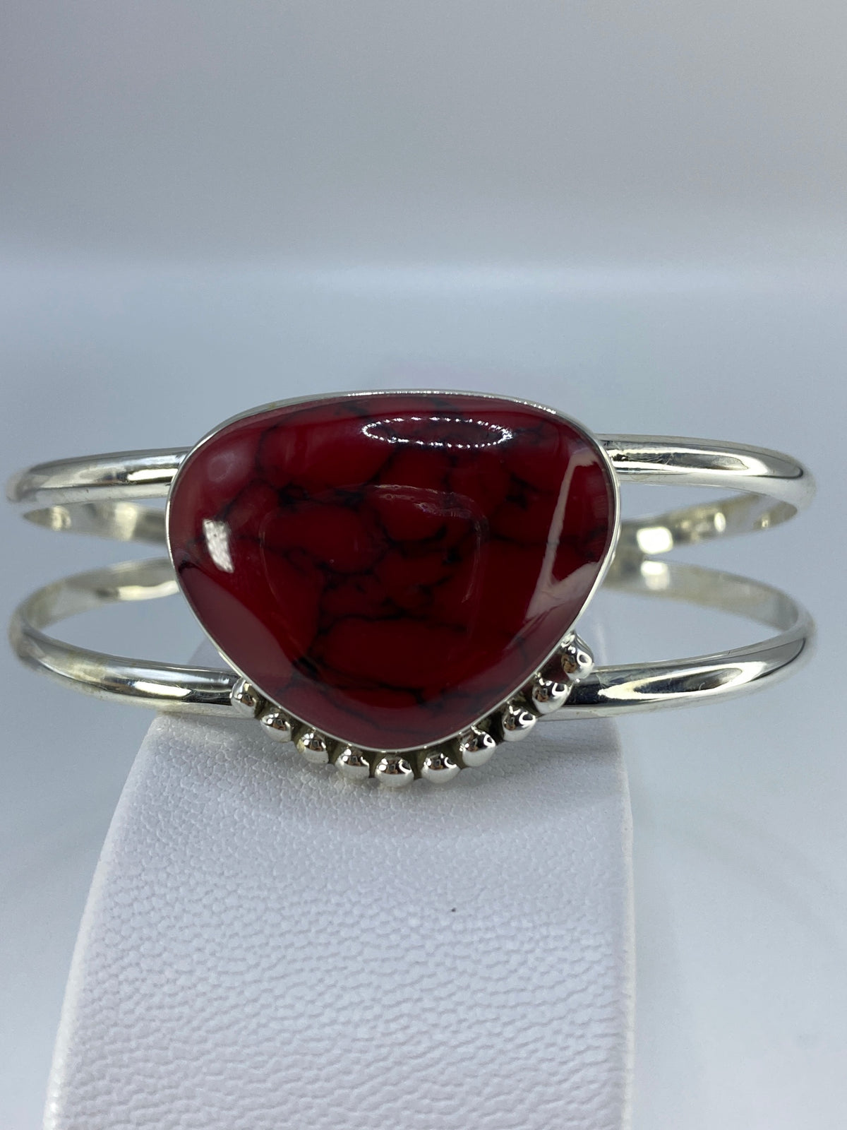 Detalle del engaste de coral rojo en plata con bolitas de orla