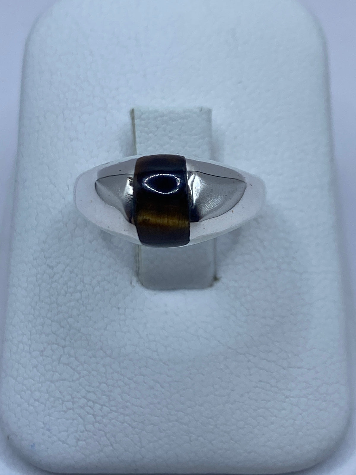 Anillo de plata 925 con Ojo de Tigre café en el dedo de una mano