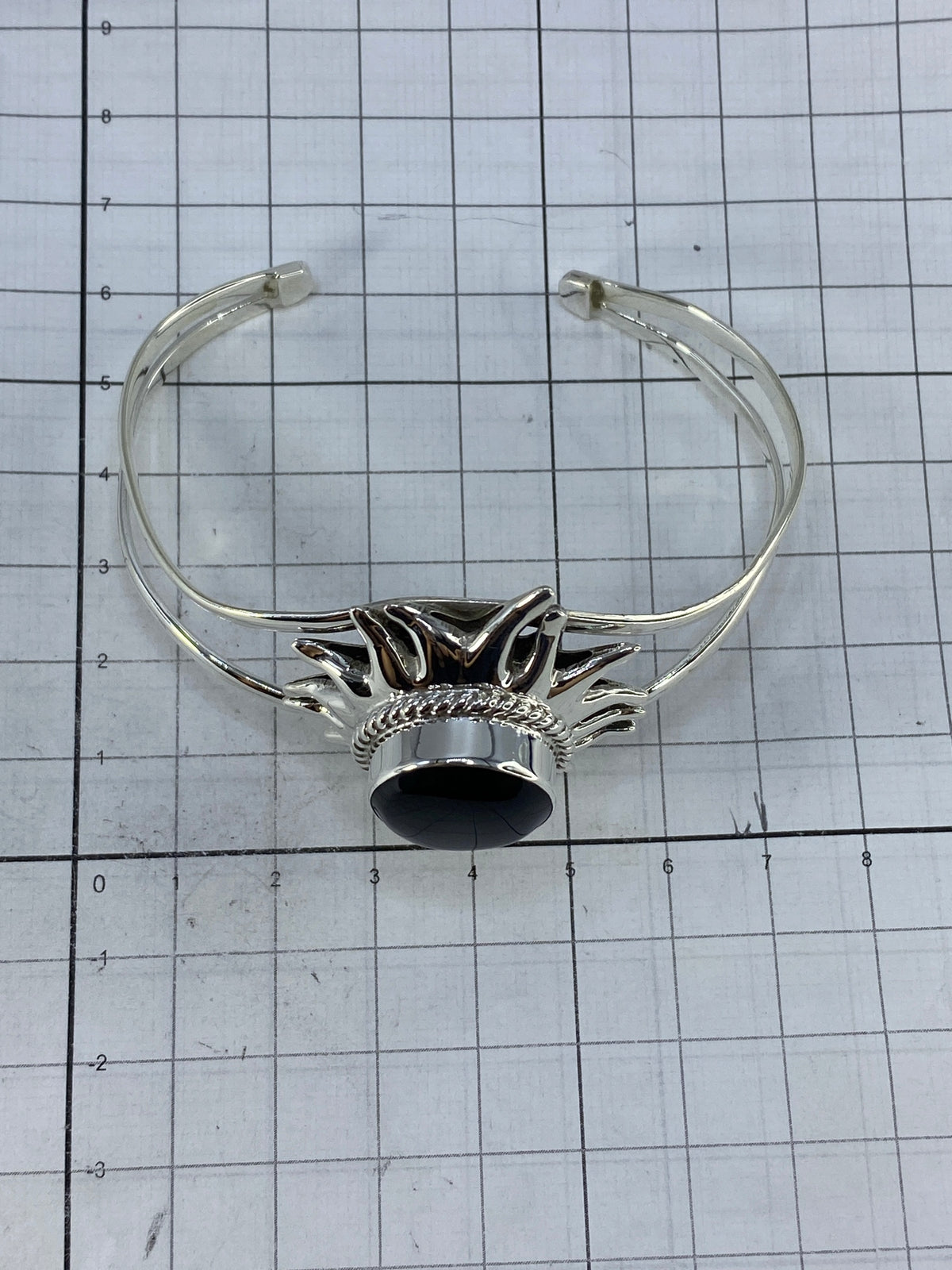 Brazalete de plata sobre fondo blanco mostrando el Quinto 925 y el diámetro interior