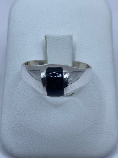 Anillo de plata 925 con onix negro engastado en la mano de un hombre