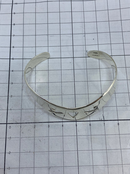 Brazalete de plata puesto en la muñeca, demostrando cómo se ajusta como esclava rígida