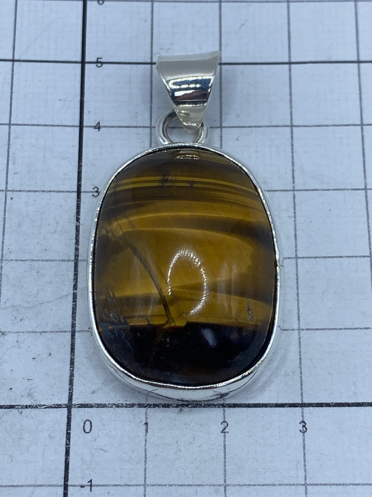 Reverso del dije en plata, mostrando el Quinto 925 grabado