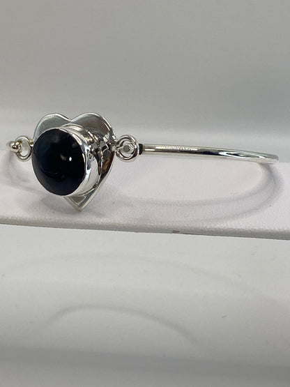 Vista frontal del brazalete rígido tipo esclava con piedra ónix pulida