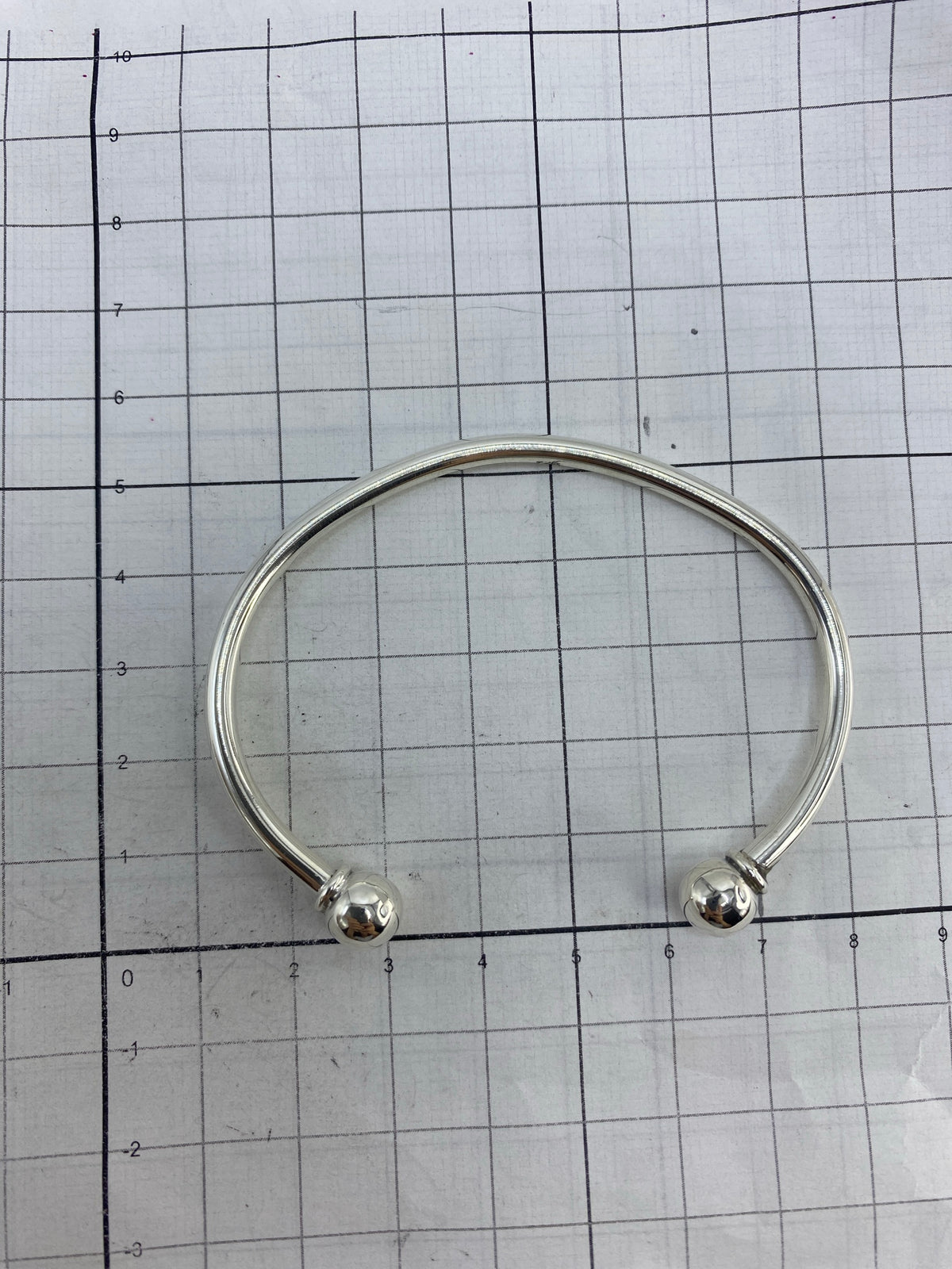 Brazalete sobre fondo blanco con escala de medición, diámetro interior 7 cm