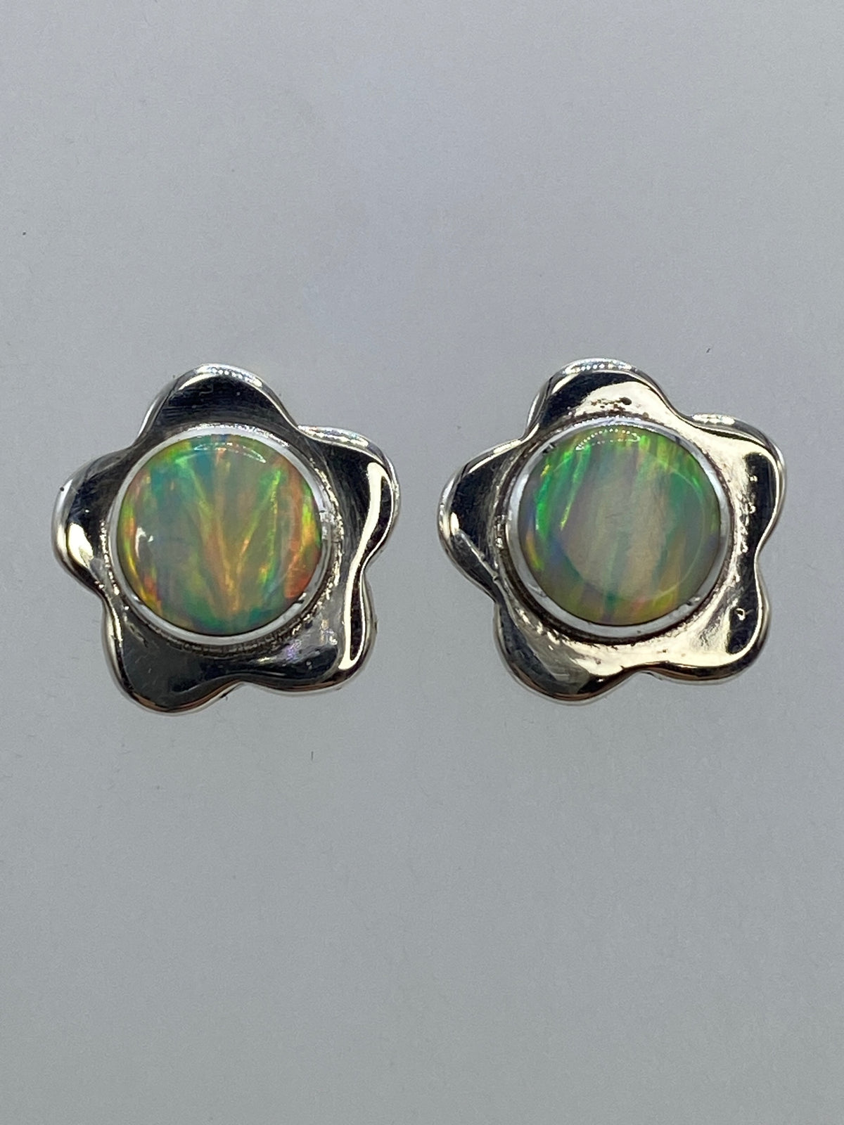 Par de aretes de plata 950 con ópalo de fuego multicolor sobre fondo gris