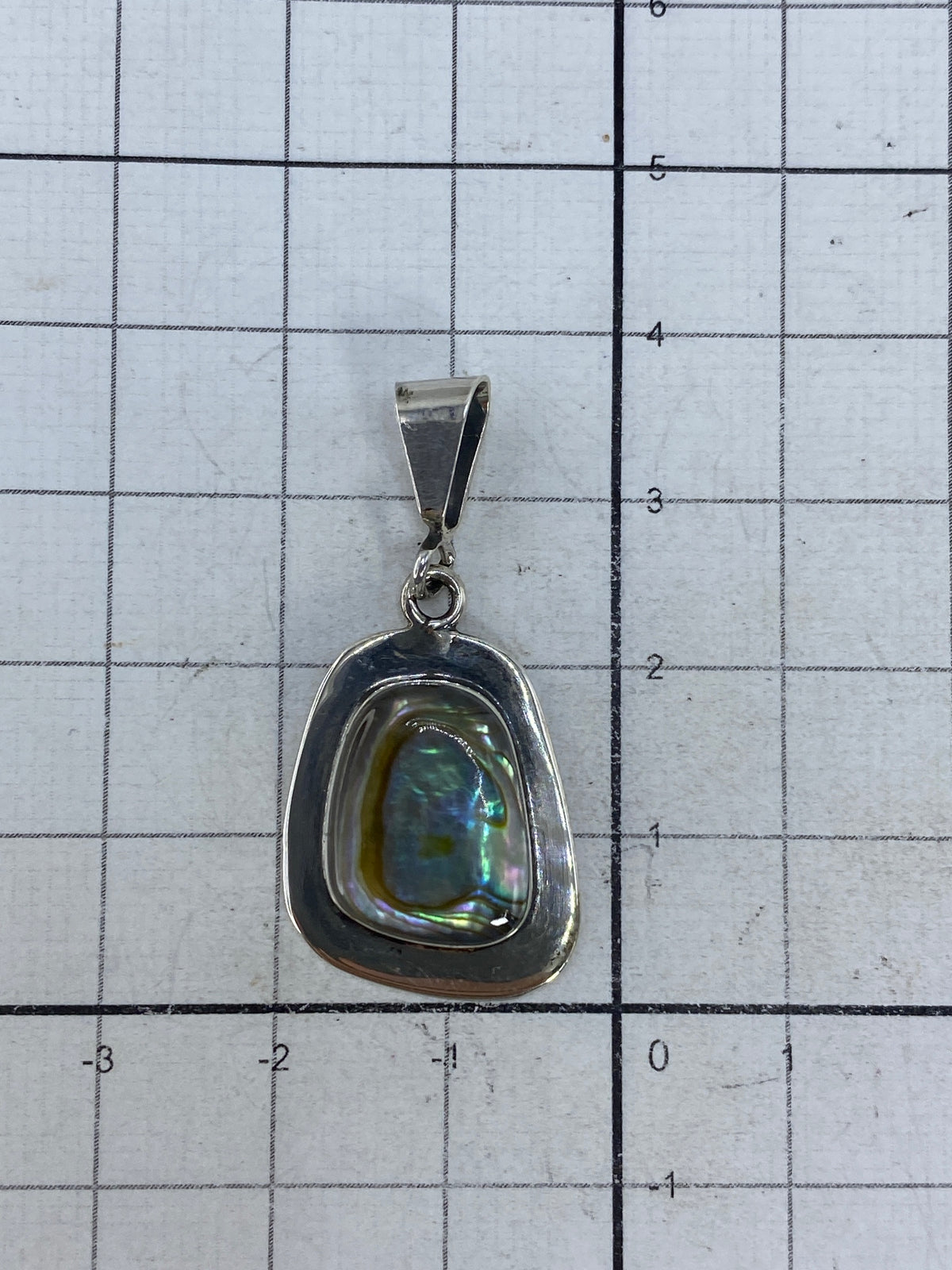 Reverso del dije de plata mostrando el Quinto 925 y el engaste artesanal