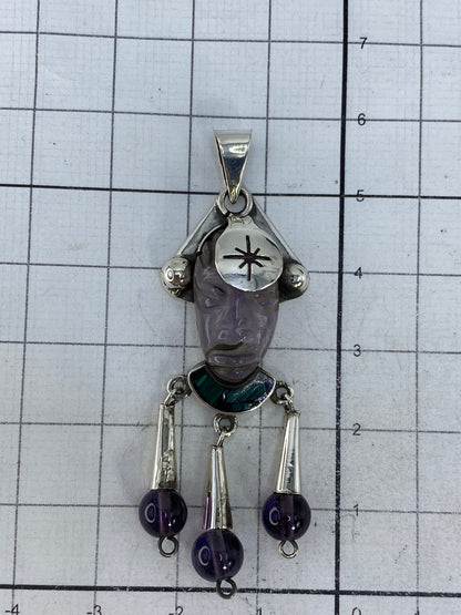 Dije de plata sobre medidor, confirmando 5.8 cm de largo