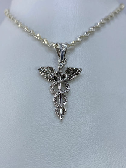 Detalle del caduceo con alas y serpientes entrelazadas