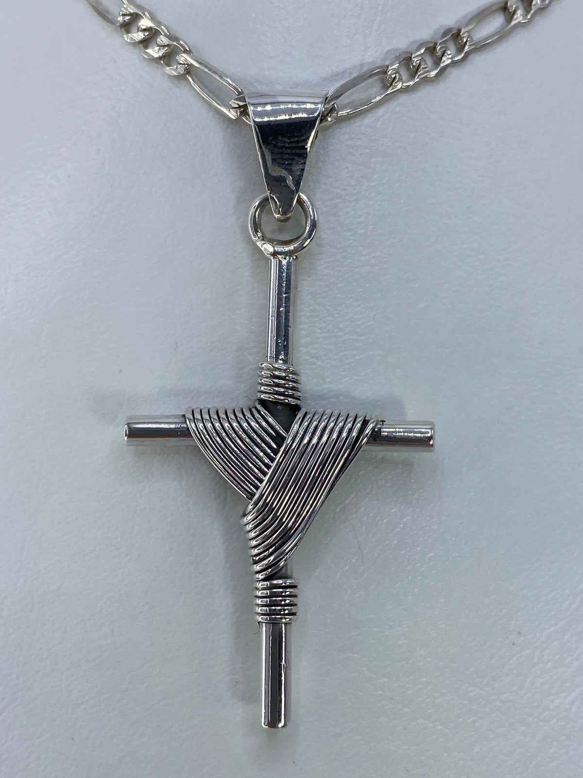 Cruz de plata 925 religiosa de Taxco con técnica combinada, colgando de cadena figaro en plata pulida