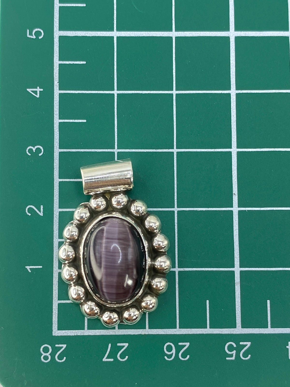 Reverso del dije de plata mostrando el hallmark 925 y el acabado pulido de Taxco