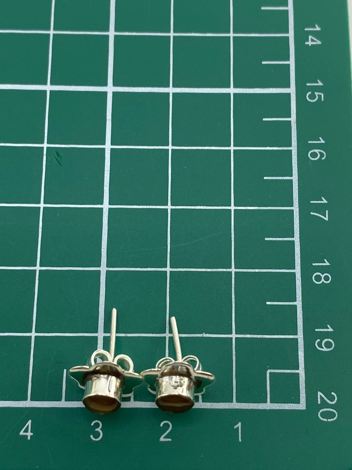 Aretes sobre fondo blanco mostrando el motivo floral completo