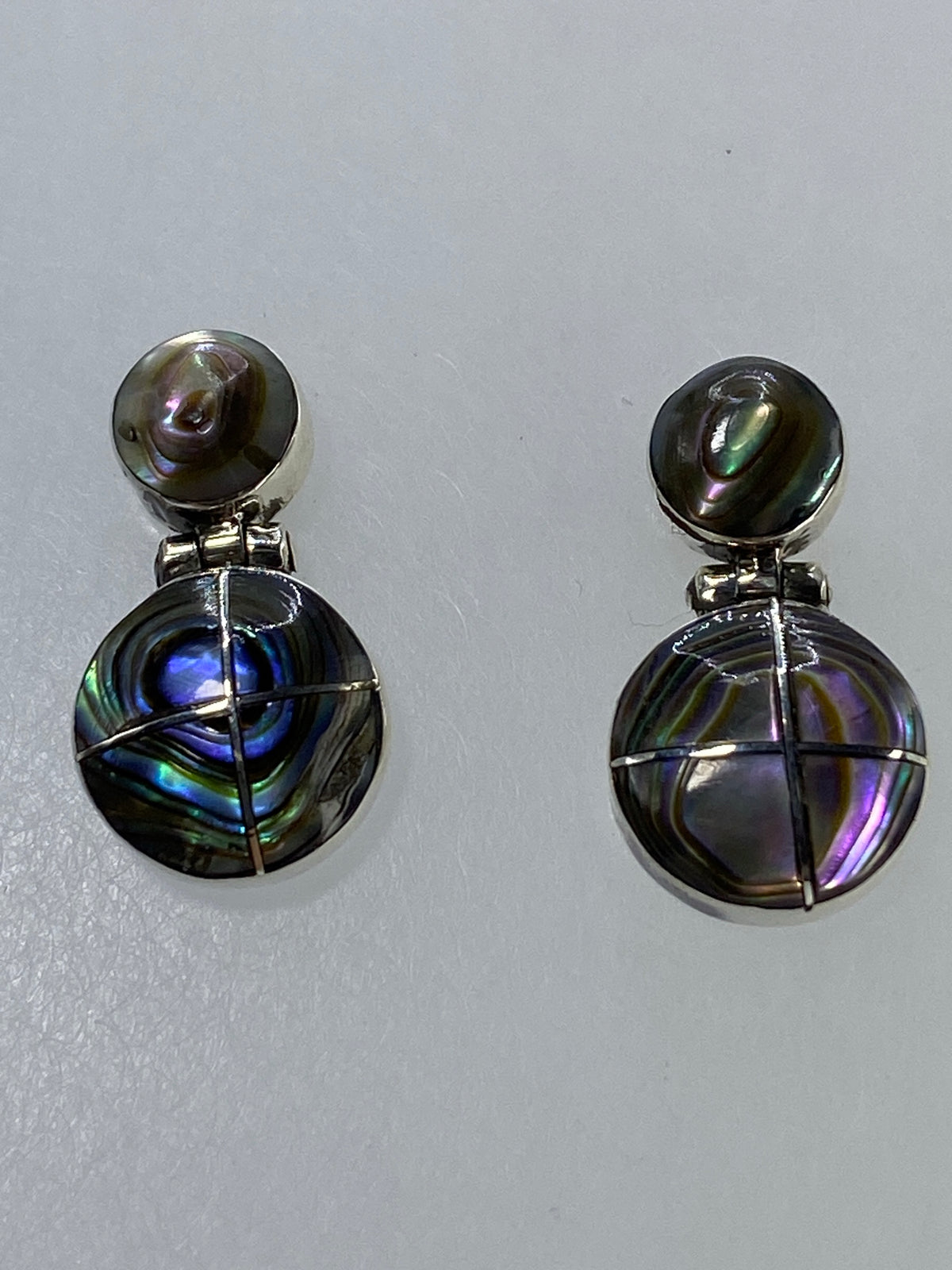 Par de aretes de plata con esferas multicolor que brillan en azul y violeta