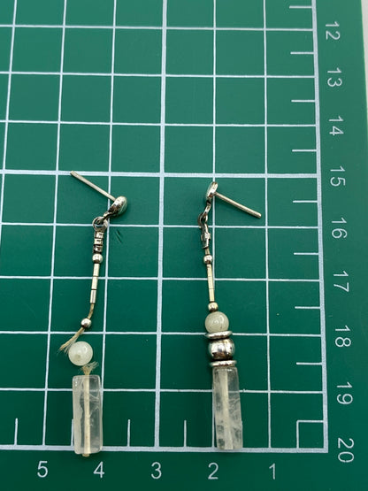 Medida en escala de los aretes: cuarzo blanco de tamaño moderado en postes de plata
