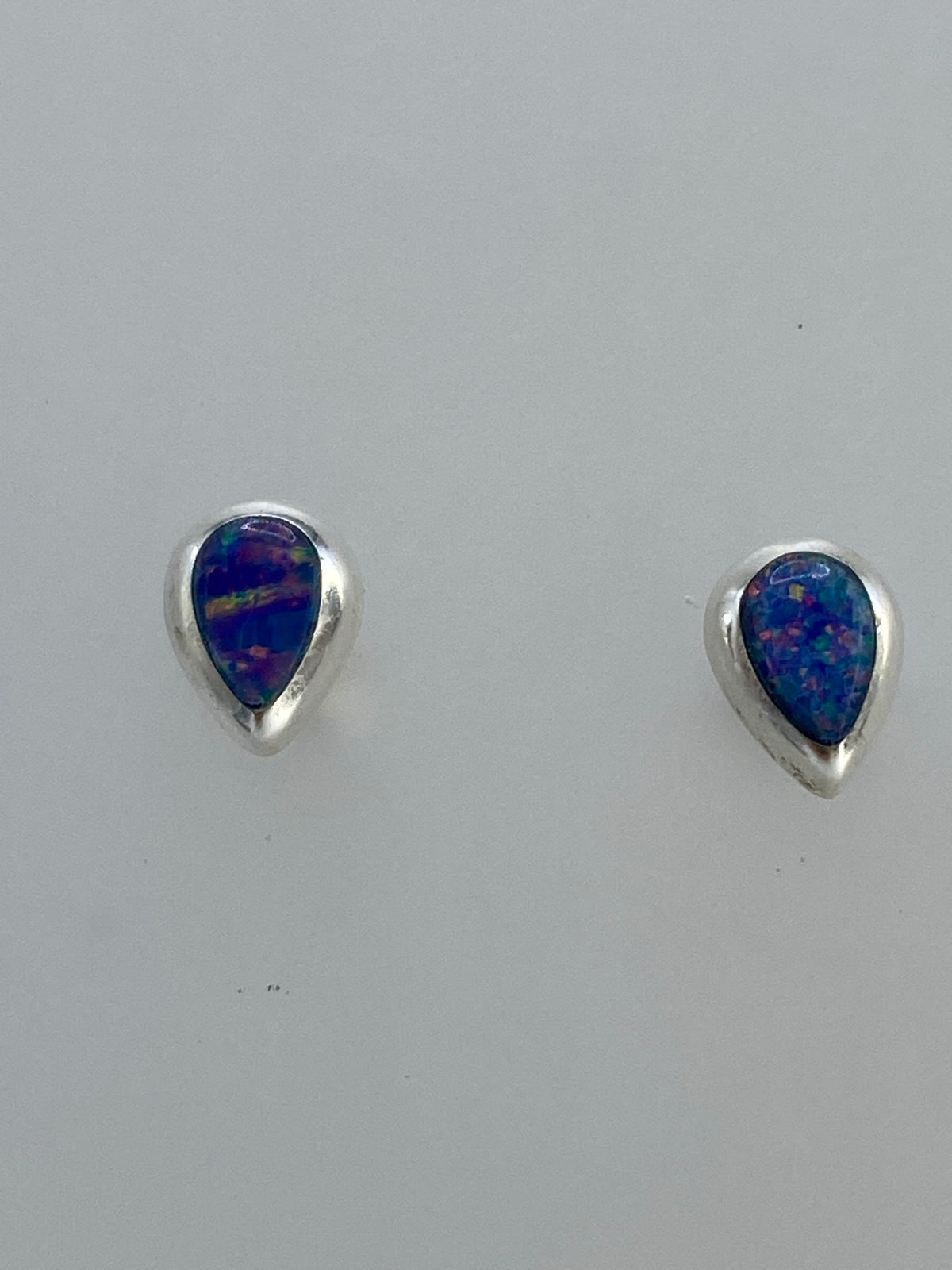 Par de aretes de plata con ópalo de fuego azul engastados a mano
