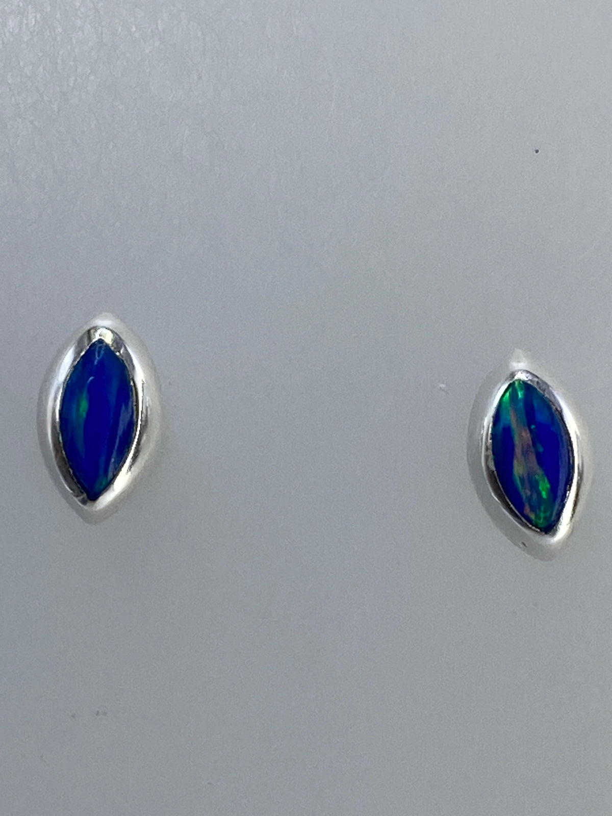 Par de aretes de plata con ópalo de fuego verde, destellos azules visibles