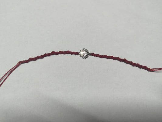 Pulsera trenzada de cordón burdeos con dije de concha en plata .925